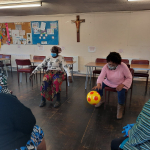 Older person showing off her skills bouncing the ball.
