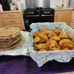 Cultural foods served at OBADO included Ugandan chapatis and fried chicken, enjoyed by older people during lunch.