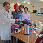Older people showing off their flask -- donation from one of them